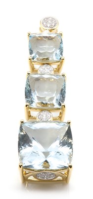 Lot 319 - An 18ct gold three stone aquamarine and diamond pendant