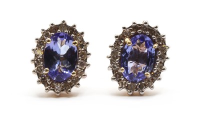 Lot 178 - A pair of gold tanzanite and diamond cluster earrings