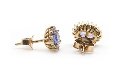 Lot 224 - A pair of gold tanzanite and diamond cluster earrings