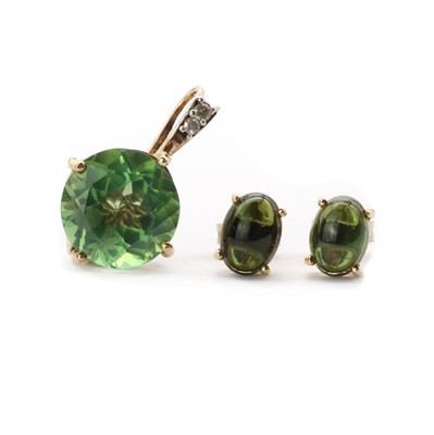 Lot 159 - A pair of gold green tourmaline cabochon earrings