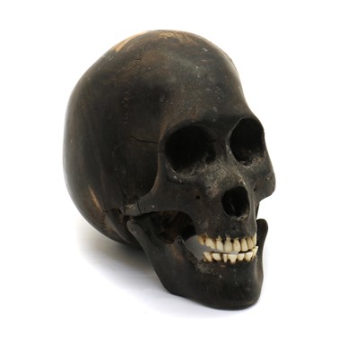 Lot 311 - A carved ebony skull