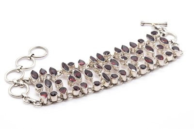 Lot 99 - A sterling silver garnet bracelet