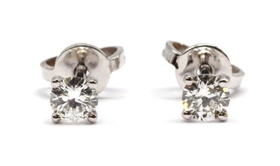 Lot 108 - A pair of white gold single stone diamond stud earrings