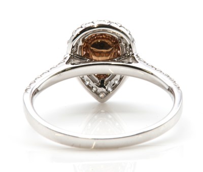 Lot 482 - A white gold fancy purplish pink diamond and diamond halo cluster ring