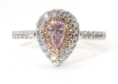 Lot 482 - A white gold fancy purplish pink diamond and diamond halo cluster ring