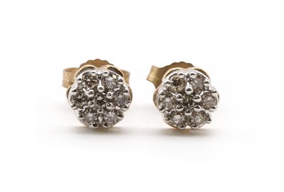 Lot 105 - A pair of gold diamond daisy cluster earrings
