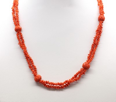 Lot 64 - A two row carved coral bead necklace