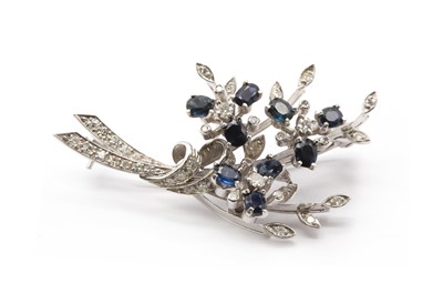 Lot 197 - An 18ct white gold sapphire and diamond spray brooch