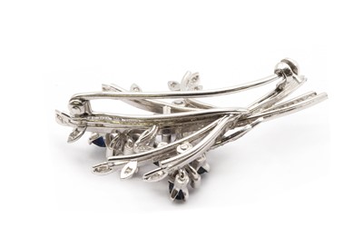 Lot 197 - An 18ct white gold sapphire and diamond spray brooch