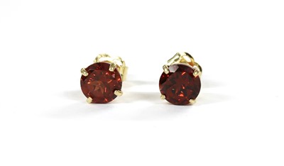 Lot 132 - A pair of gold single stone garnet stud earrings