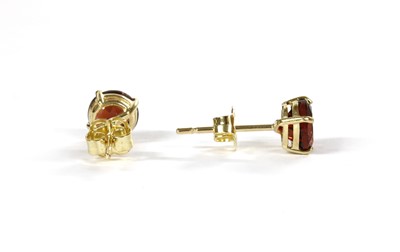 Lot 132 - A pair of gold single stone garnet stud earrings