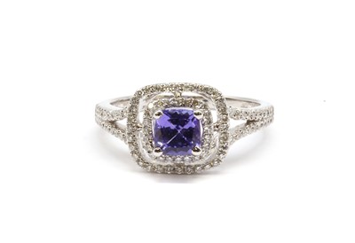 Lot 168 - An 18ct white gold tanzanite and diamond halo cluster ring