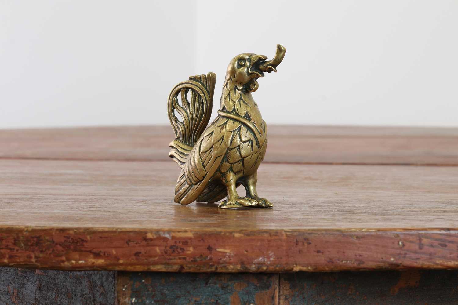 Lot 115 - A bronze oil lamp in the form of a cockerel