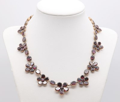 Lot 13 - A George III flat cut foil backed garnet pansy necklace, c.1800