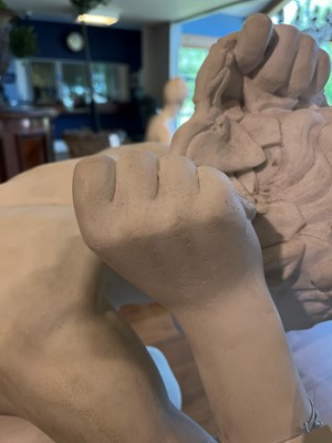 Lot 230 - A marble figure of a crouching faun