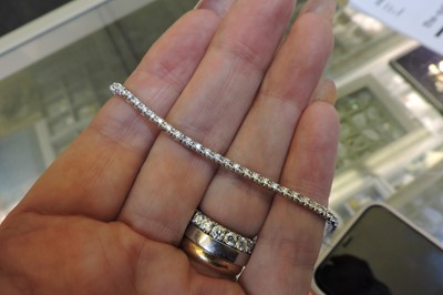 Lot 372 - A single row diamond line bracelet