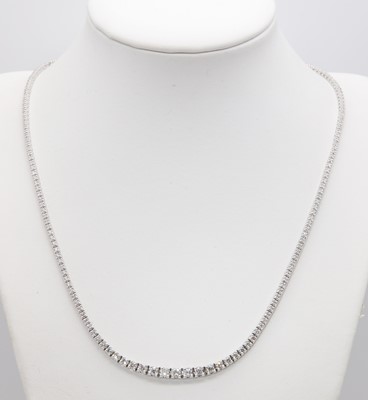 Lot 415 - A graduated diamond set rivière necklace