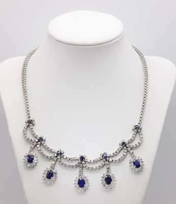 Lot 428 - An Italian white gold sapphire and diamond swag and fringe necklace