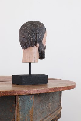 Lot 200 - A carved and painted wooden head of a saint