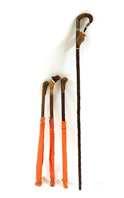 Lot 159 - A modern carved walking stick and three beater's flag sticks
