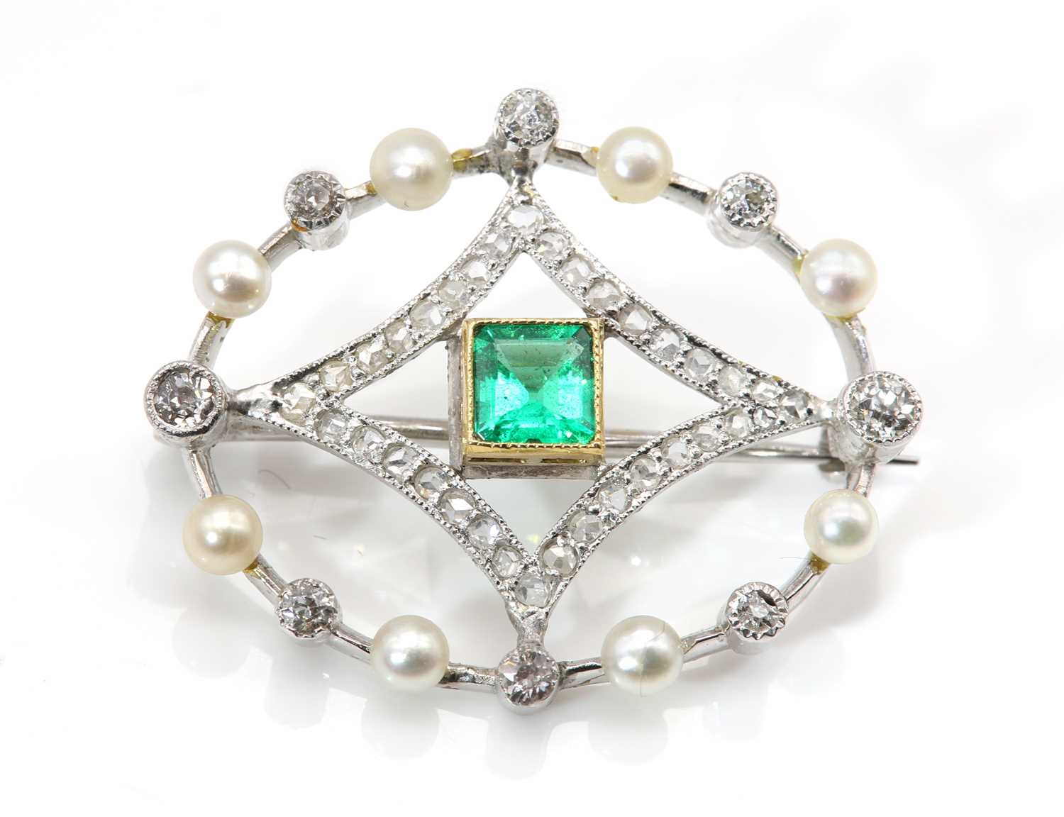 Lot 168 - A two colour gold emerald, seed pearl and diamond brooch, c.1915-1925