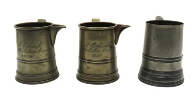 Lot 190 - A group of three 19th century pewter quart mugs