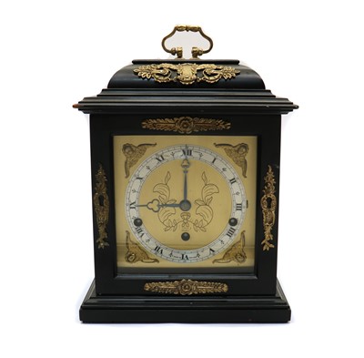 Lot 157 - An ebonised caddy top mantel clock