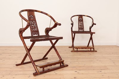 Lot 173 - A pair of Chinese hardwood horseshoe-back folding chairs