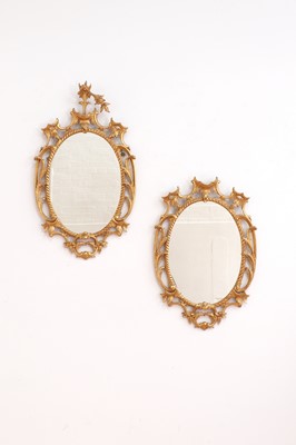 Lot 616 - A pair of George III-style giltwood wall mirrors