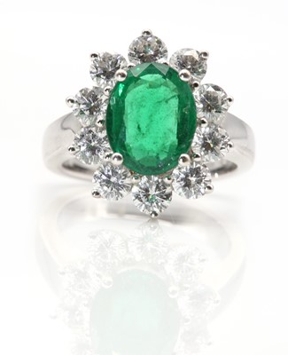 Lot 126 - An 18ct white gold Zambian emerald and diamond oval cluster ring