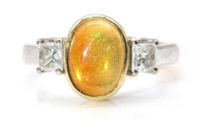 Lot 127 - An 18ct yellow and white gold three stone fire opal and diamond ring