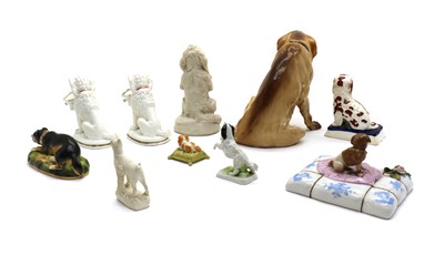 Lot 93 - A collection of pottery and porcelain figures of dogs