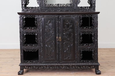 Lot 128 - A carved hardwood display cabinet