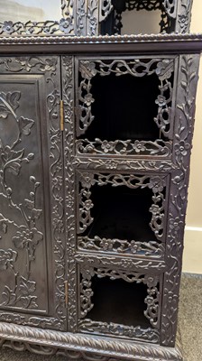Lot 128 - A carved hardwood display cabinet