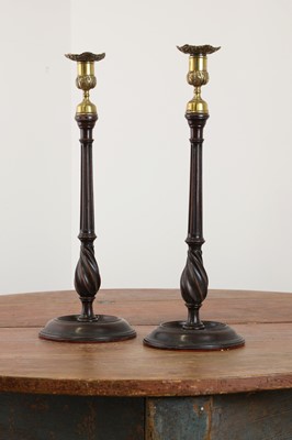 Lot 520 - A pair of George III mahogany candlesticks in the manner of Gillow