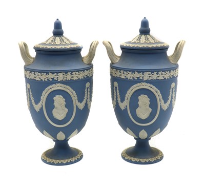 Lot 79 - A pair of Wedgewood Jasperware twin-handled vases and covers