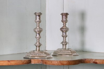 Lot 315 - A pair of William III Britannia standard cast candlesticks