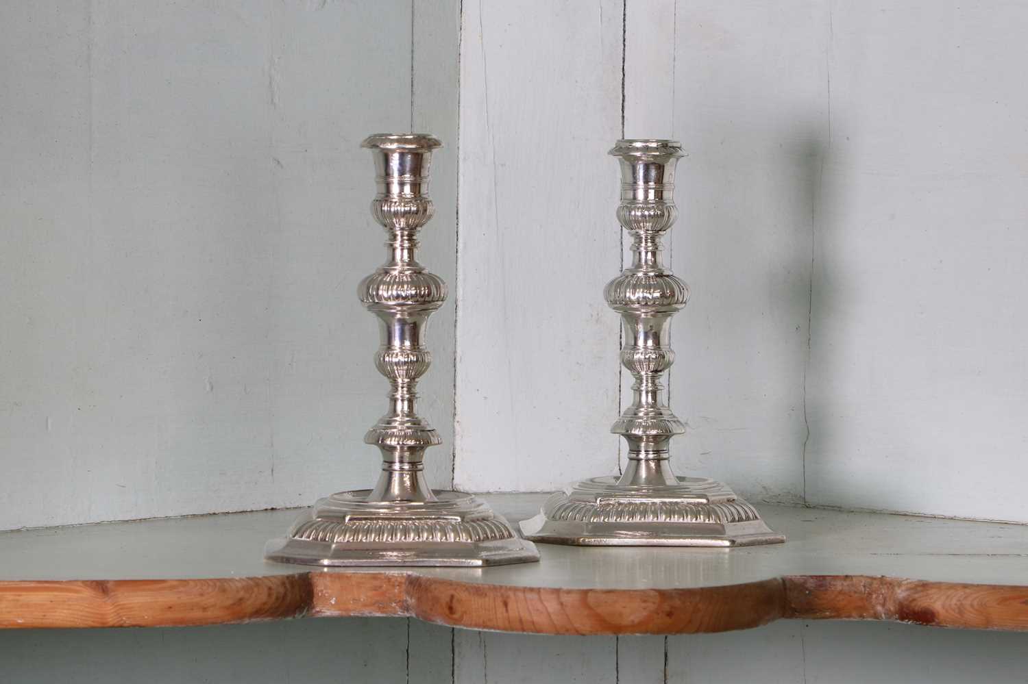 Lot 317 - A pair of Queen Anne cast Britannia standard silver candlesticks
