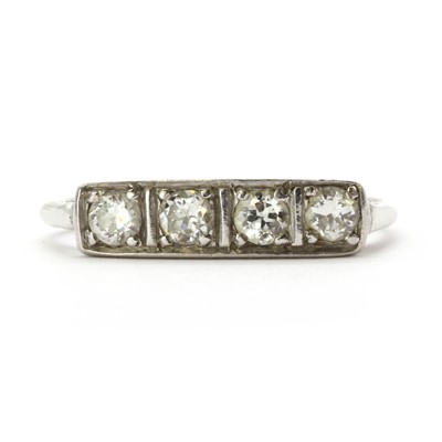 Lot 25 - An Art Deco gold four stone diamond ring