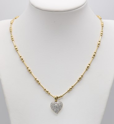 Lot 396 - An 18ct yellow and white gold diamond set heart shaped necklace, by David Morris, c.1995