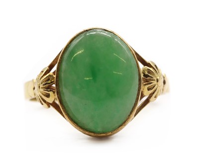 Lot 241 - A gold jade cabochon ring