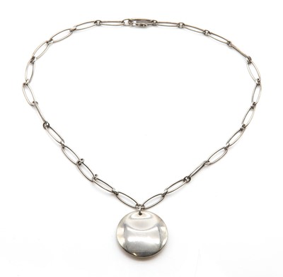 Lot 237 - A sterling silver disc pendant, by Elsa Peretti for Tiffany & Co.