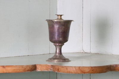 Lot 323 - A small unmarked silver communion cup with paten