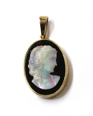 Lot 325 - A gold mounted opal and onyx composite cameo pendant