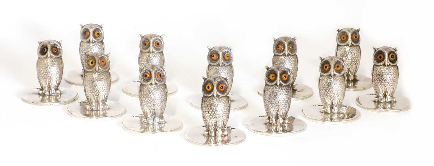 Lot 23 - A set of twelve matched silver owl place card holders