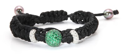 Lot 531 - An emerald and diamond drawstring cord bracelet