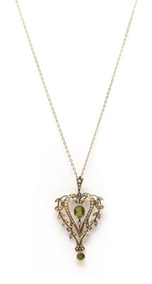 Lot 43 - An Edwardian gold peridot and split pearl pendant
