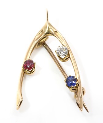 Lot 104 - A late Victorian sapphire, diamond and ruby wishbone brooch