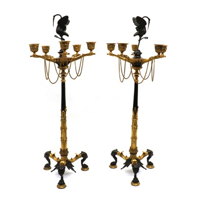 Lot 294 - A pair of Regency style bronze and gilt bronze candelabra