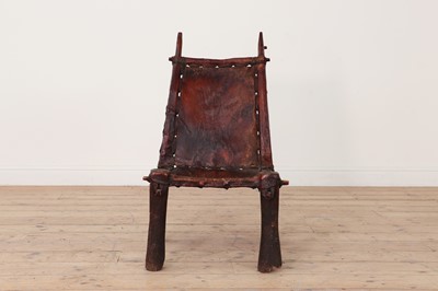 Lot 77 - A tribal hardwood and hide low chair